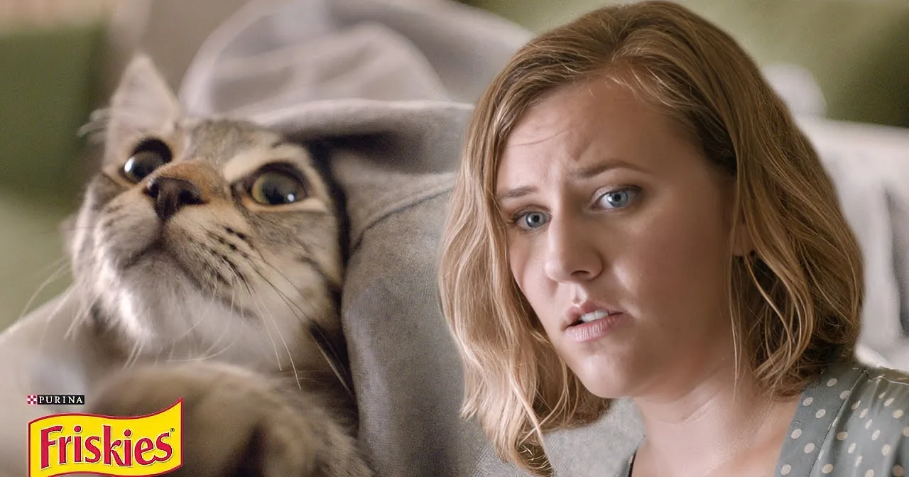A cat with wide eyes and a woman in a polka dot shirt looking concerned.