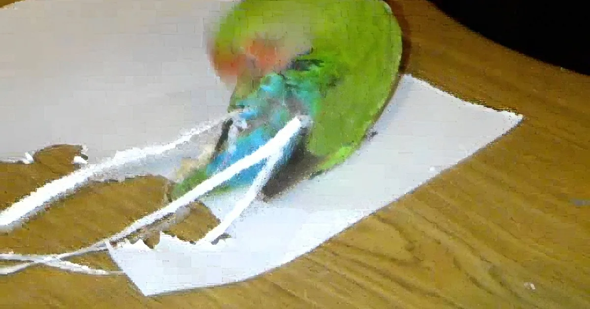 A green parrot with a red face is perched on a piece of paper, holding a string with its beak.