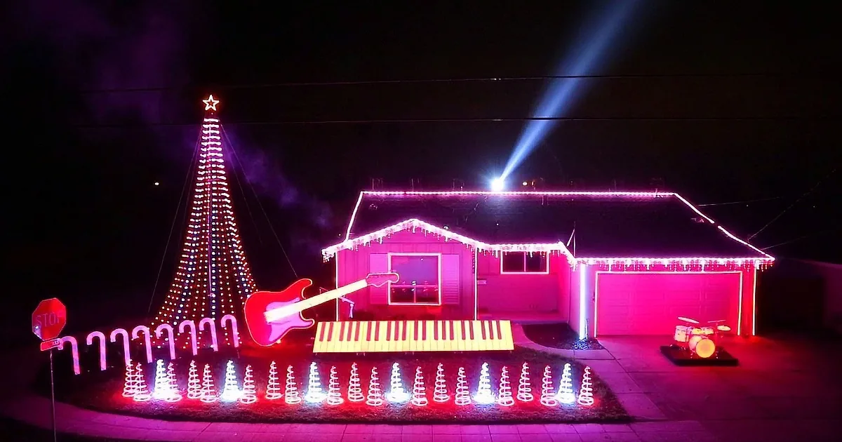 A house adorned with vibrant pink lights and musical instrument decorations, creating a festive and lively scene.