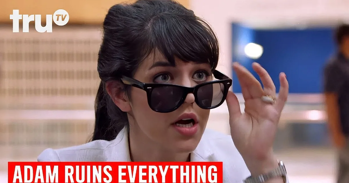 A woman adjusts her sunglasses, looking surprised, with "Adam Ruins Everything" text below.