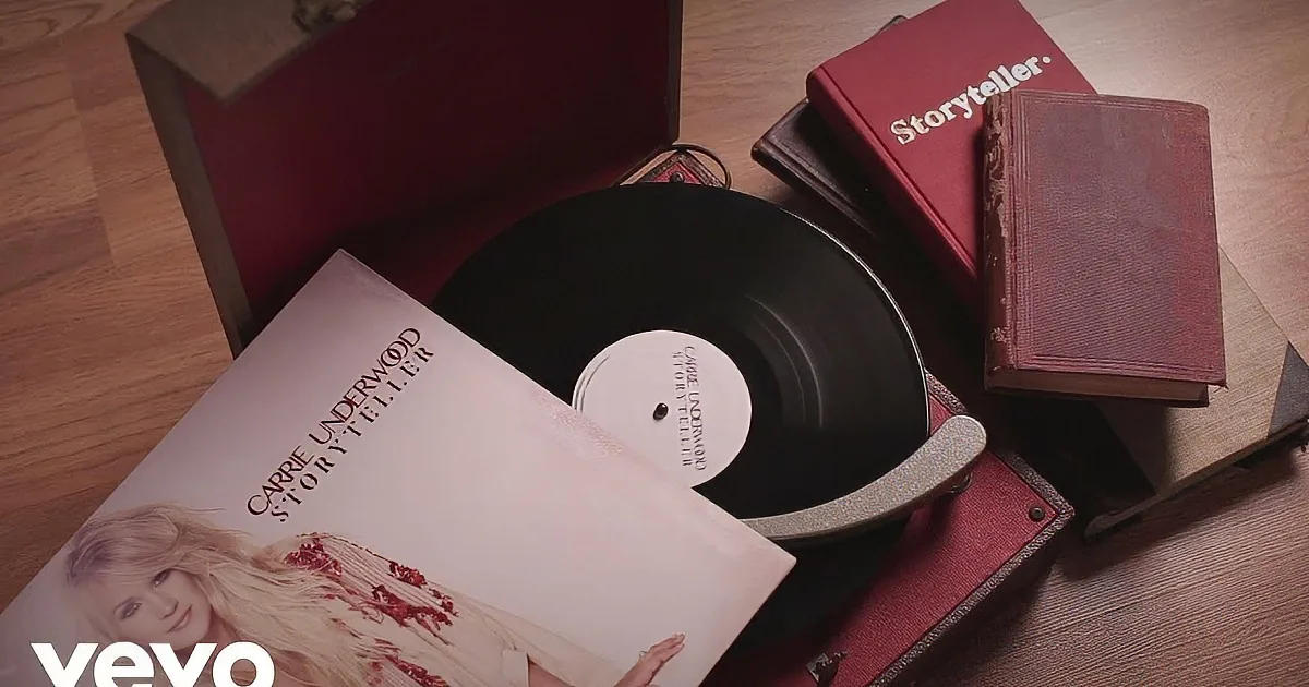 A vinyl record sits on a turntable surrounded by books and album covers.