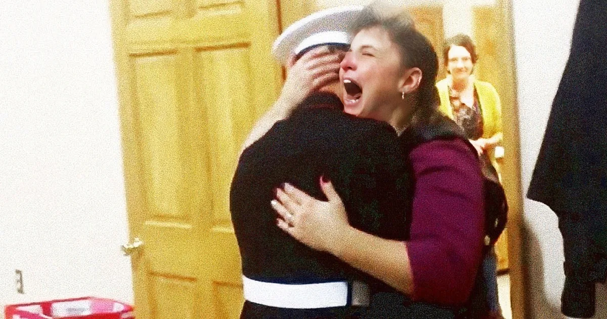 A woman in a sailor uniform hugs another woman in a purple jacket, both appear emotional.