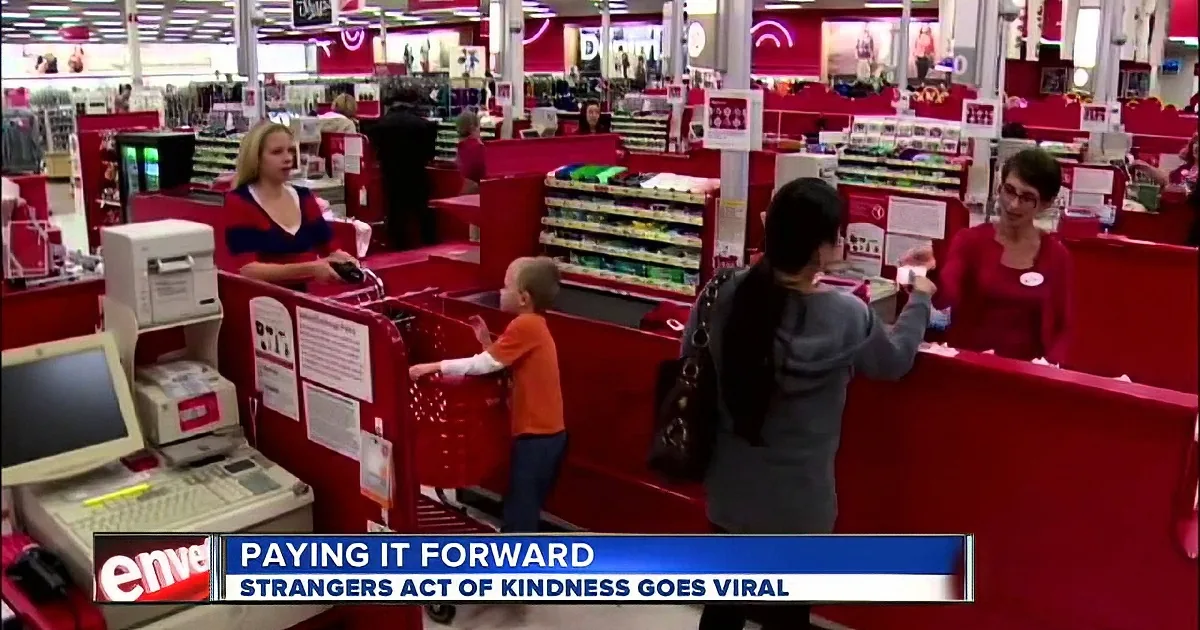 A woman hands money to a cashier at a Target checkout, with a child nearby.