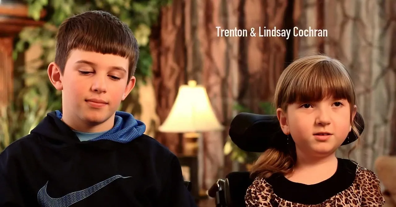 A young boy and girl sit side by side, the boy in a blue hoodie and the girl in a leopard print dress, with text above...