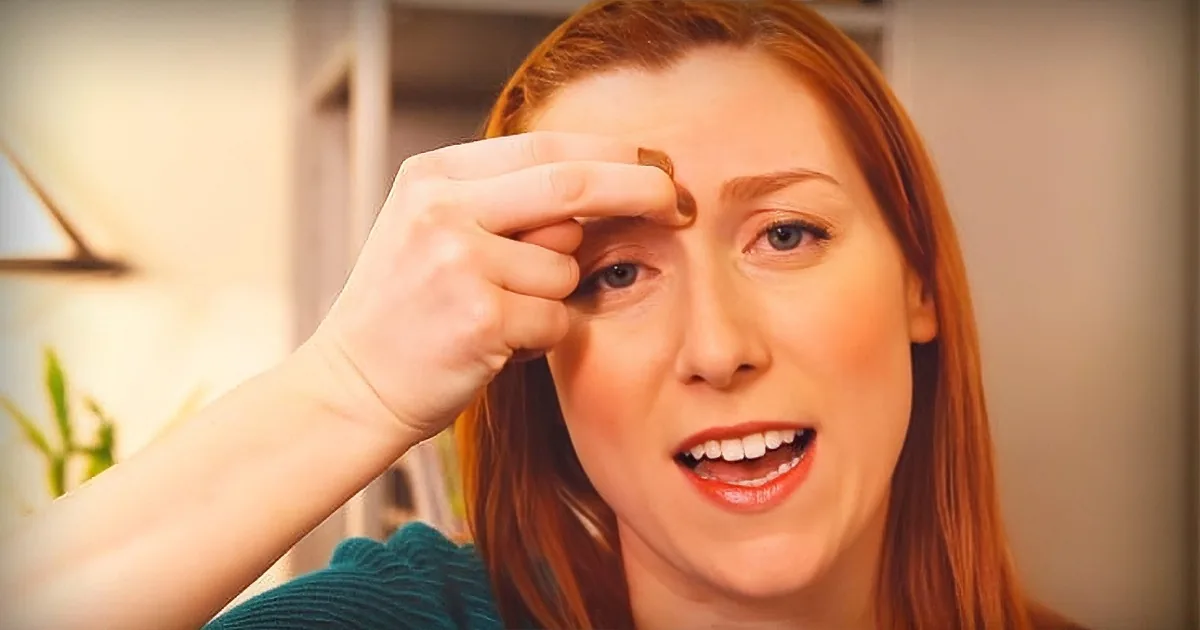 A woman with red hair is shown in two close-up shots, one with her hand near her eye and the other with her mouth open.