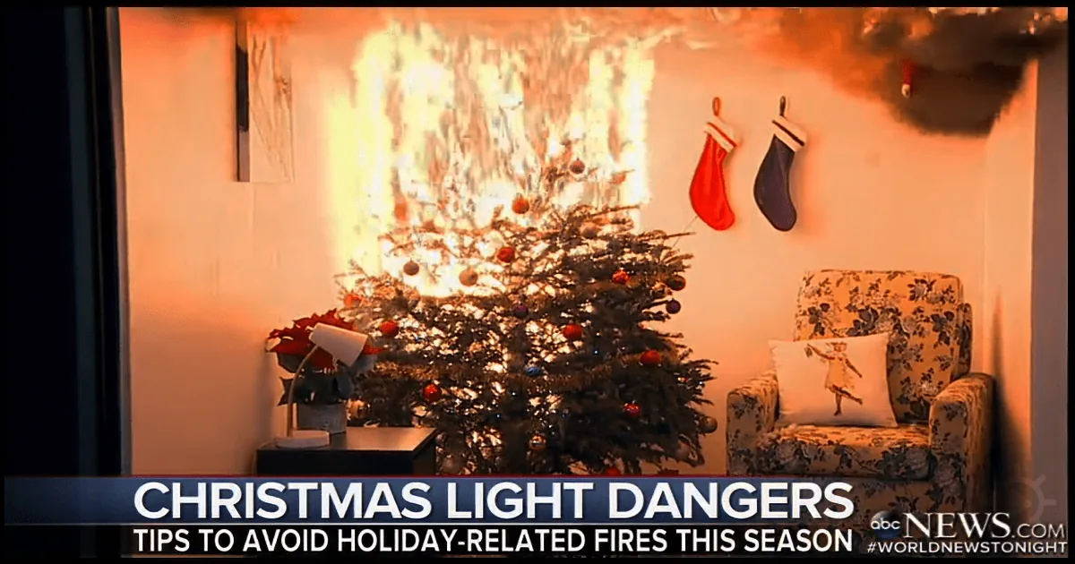 A Christmas tree with lights on fire, smoke rising, in a living room setting.