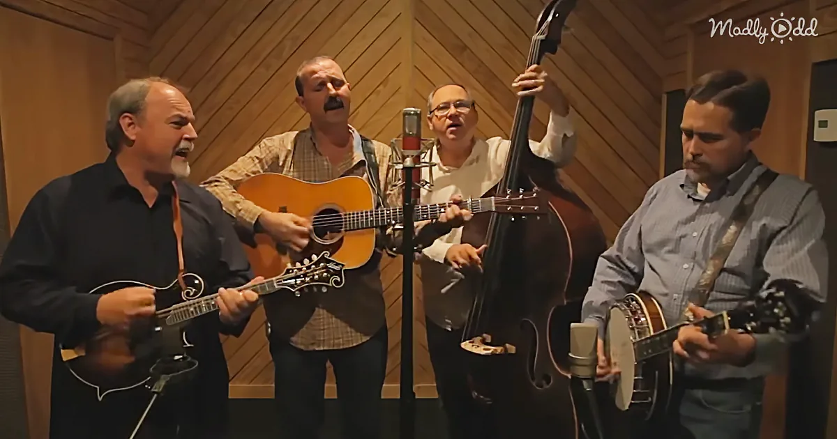 A group of four men play acoustic instruments in a recording studio.