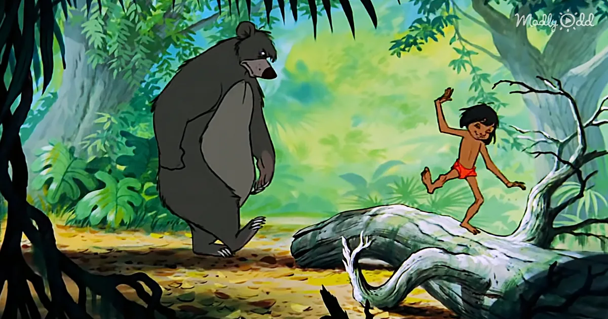 Mowgli dances on a log while Baloo the bear watches in a lush jungle setting.