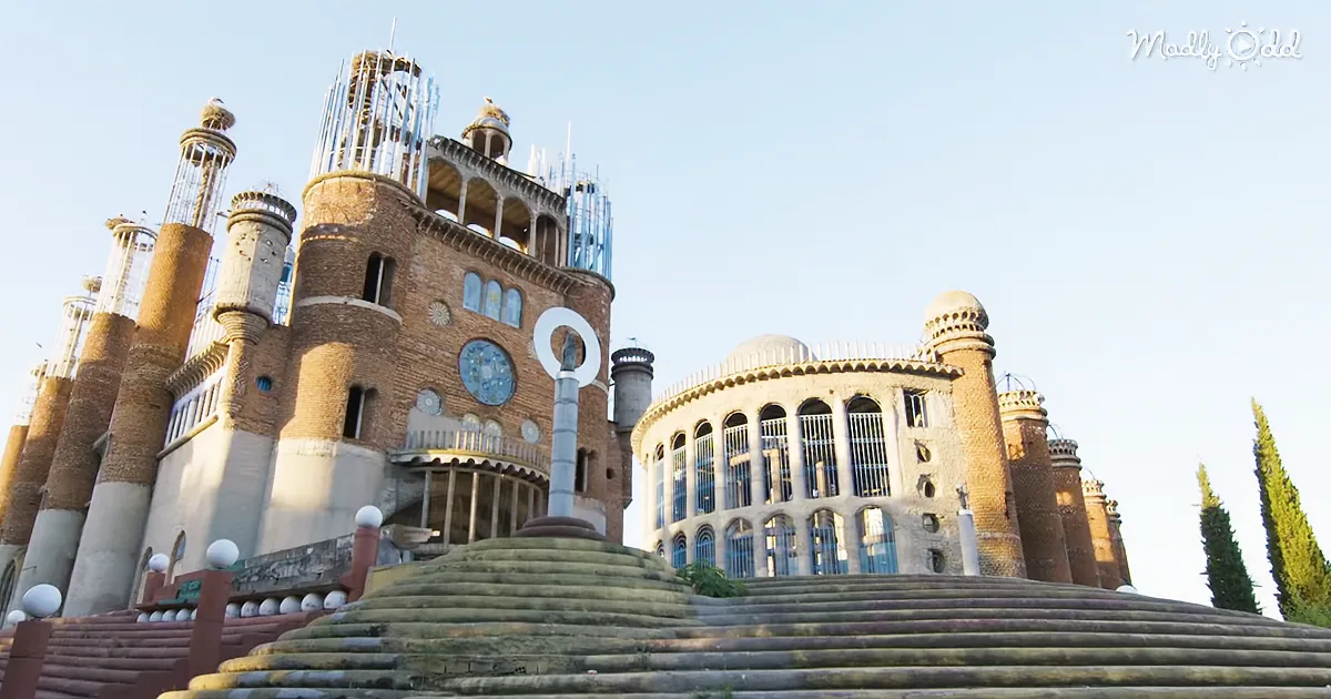 A grand, ornate building with intricate architecture and steps leading up to it.