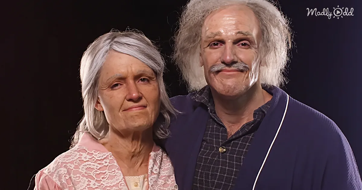 An older couple, the man with white hair and mustache, stands close to the woman with gray hair, both smiling softly.