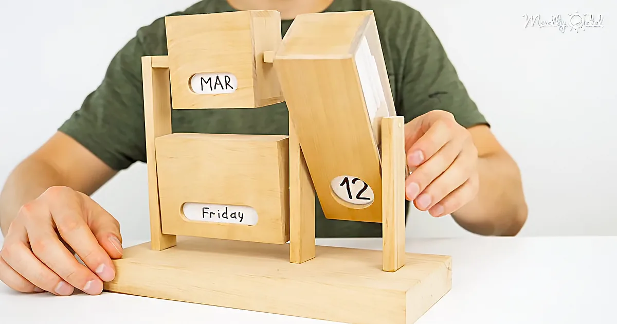 A person adjusts a wooden perpetual calendar showing March 12, Friday.