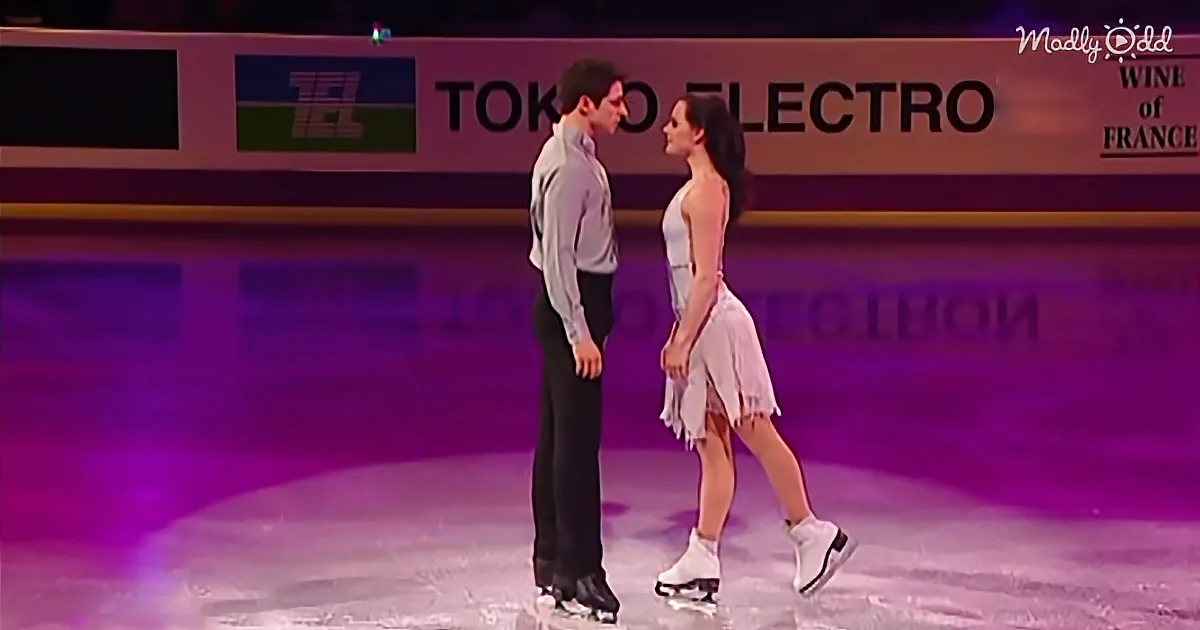 A couple in formal attire stands on an ice rink, facing each other, with a "Tokyo Electro" sign in the background.