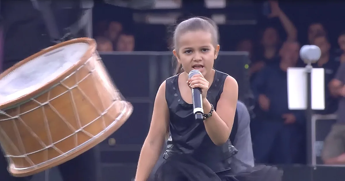 Girl Shocks Crowd by Singing 'We Will Rock You' With Drumline