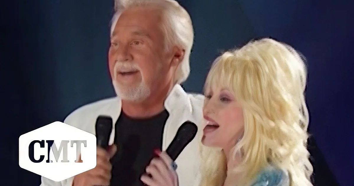 Kenny Rogers and Dolly Parton sing together on stage, both holding microphones.