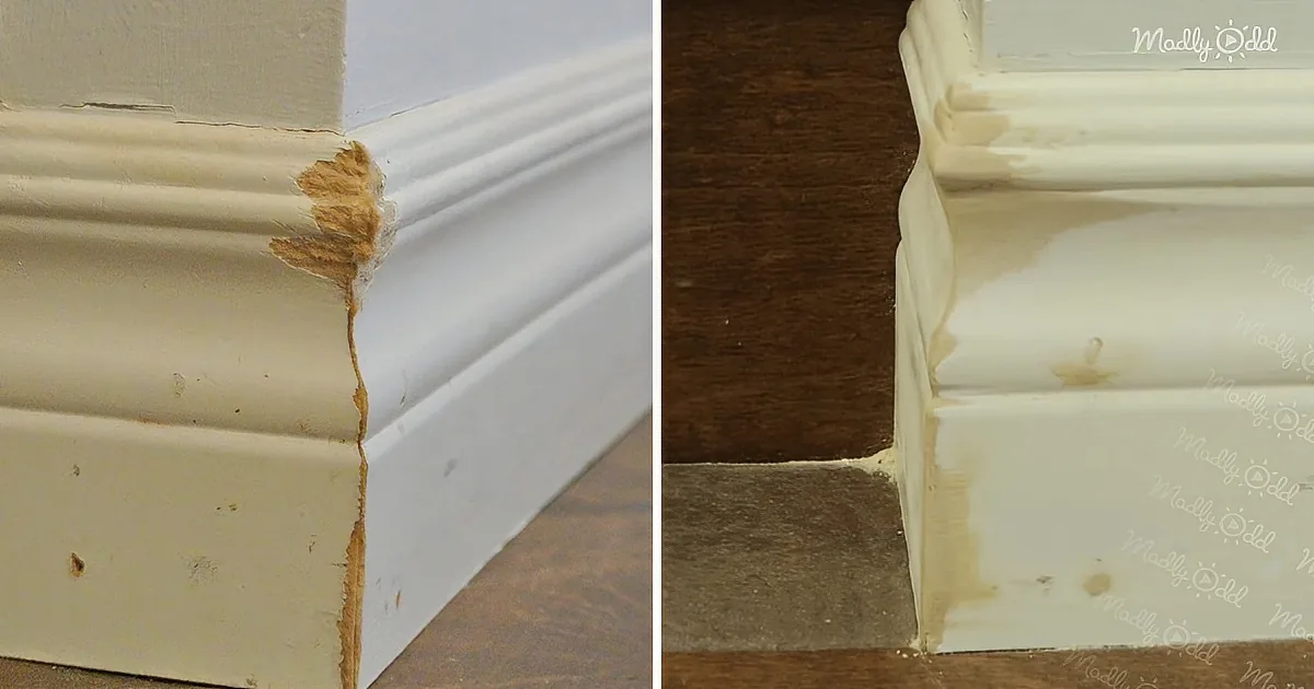 A damaged white baseboard with peeling paint and a visible crack.