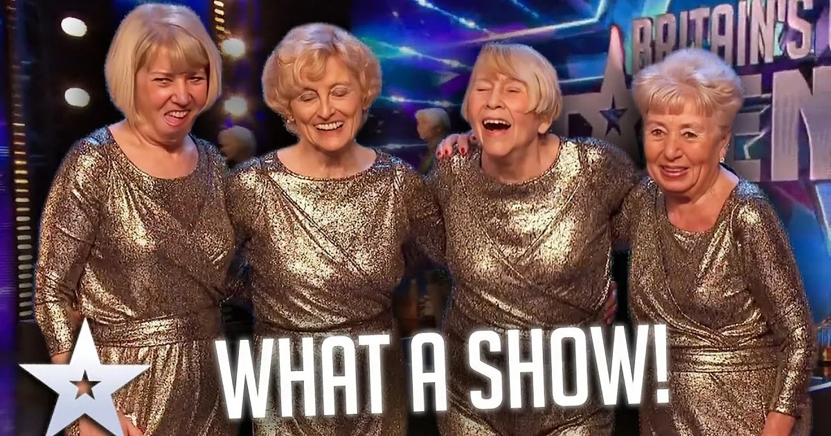 Four performers in shiny outfits dance on illuminated boxes on a stage with "Britain's Got Talent" backdrop.