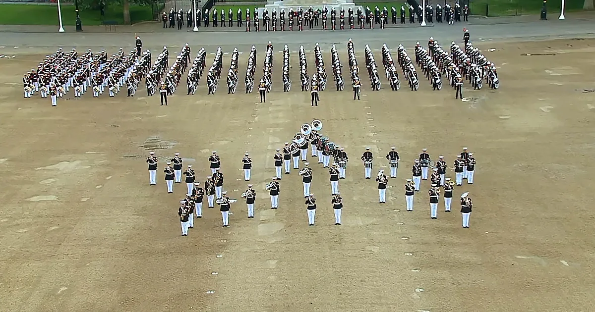 A military band in formation on a parade ground, playing instruments.