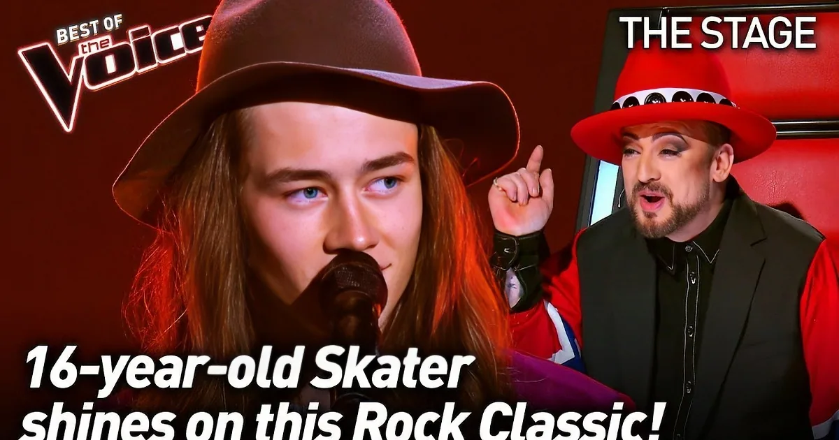 A person with long hair and a hat sings into a microphone against a warm orange background.