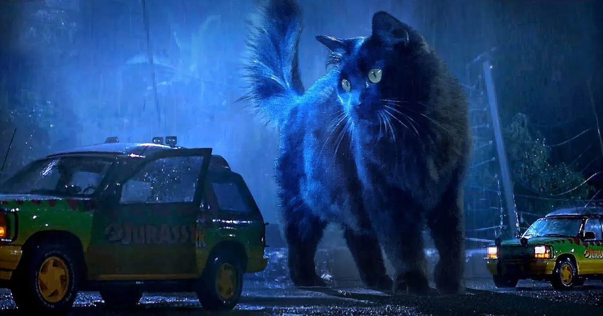 A large, glowing-eyed black cat looms behind a Jurassic-themed car in a rainy, dimly lit scene.