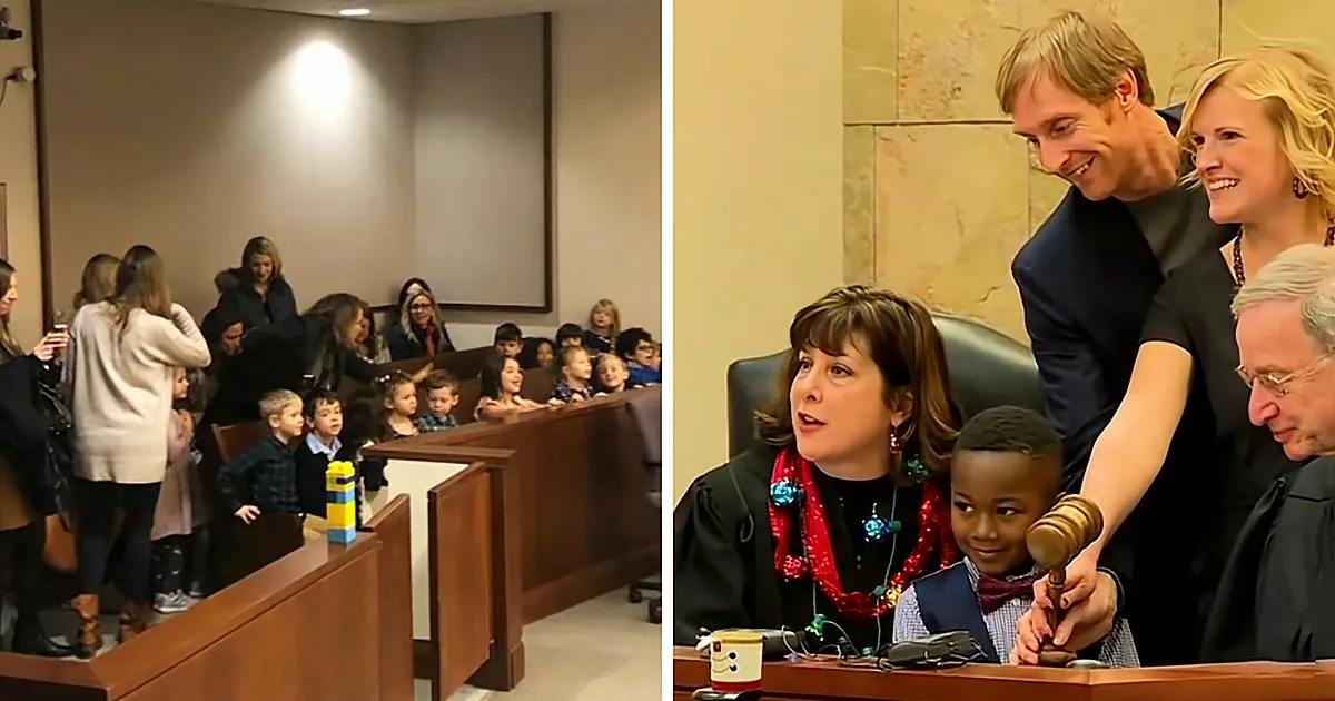A judge holds a gavel while a child sits on her lap, surrounded by adults and children in a courtroom.