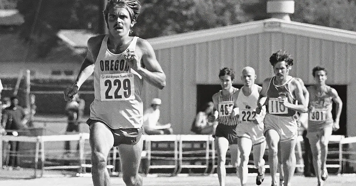 A runner in a gray tank top with "Oregon" and number 229 leads a group of athletes in a race.