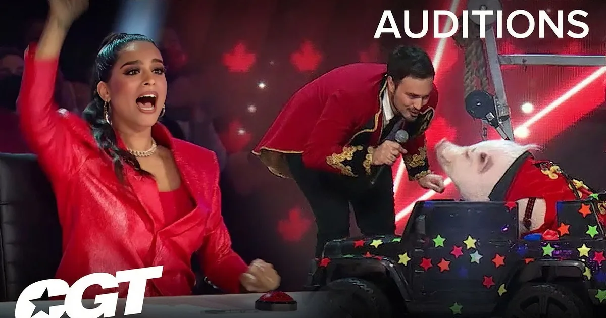 A woman and a dog perform on stage with red balloons and heart patterns in the background.
