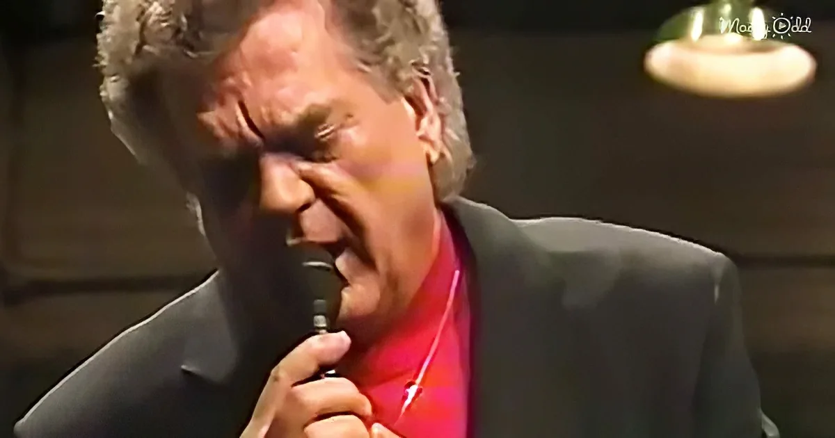 Conway Twitty holding microphone passionately during a performance