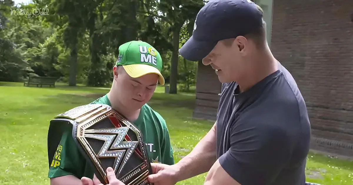 A man in a green cap holds a WWE championship belt while another man in a cap looks on.