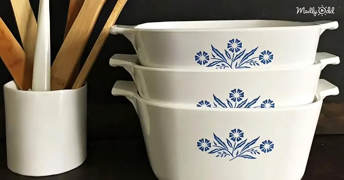 Stacked white bowls with blue floral designs, wooden spoons in a white holder.