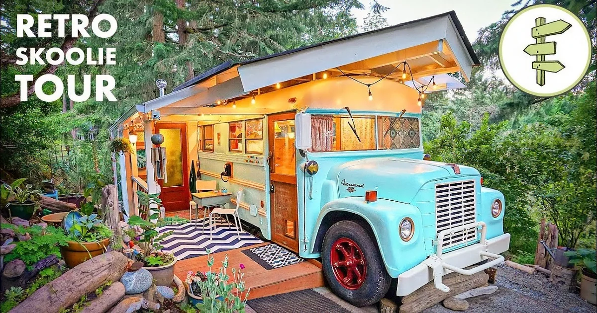 A cozy, compact living space with a kitchen, seating area, and sleeping quarters, featuring wooden walls and a patterned rug.