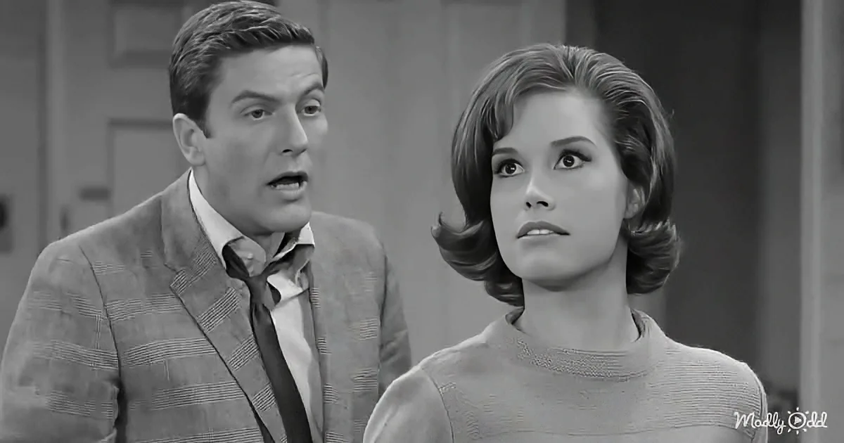 A man in a suit and tie looks surprised, while a woman in a sweater looks concerned.