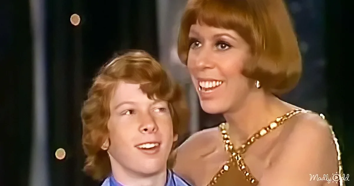 A woman with short, styled hair and a gold necklace smiles alongside a younger person with curly hair.