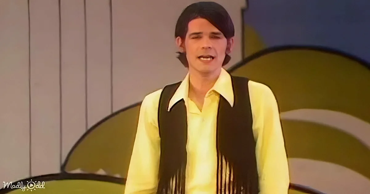 B.J. Thomas performing with dancers in colorful clothes holding umbrellas