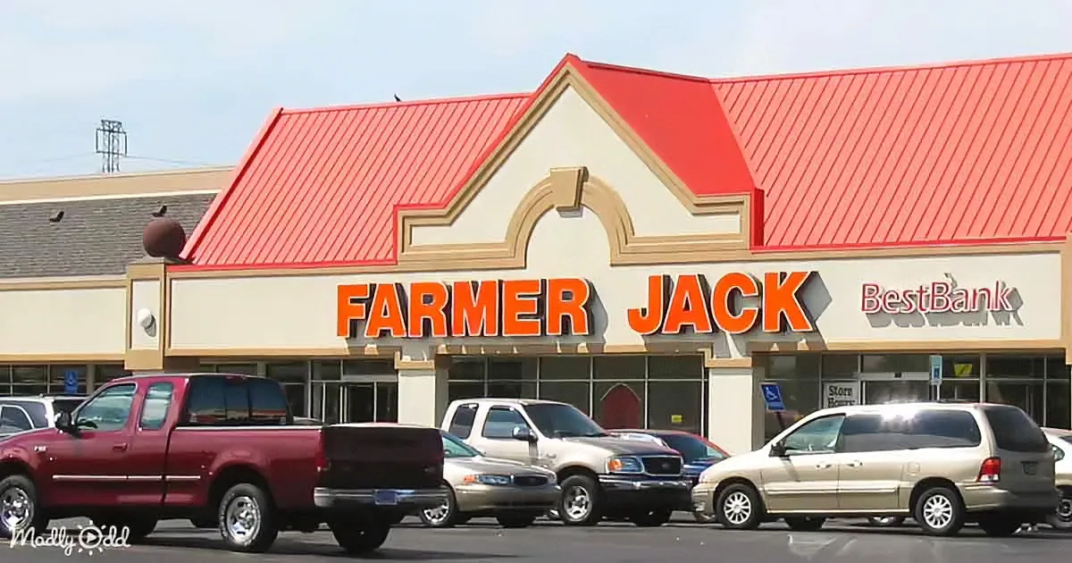 Farmer Jack store with red roof, orange sign, and cars parked in front.