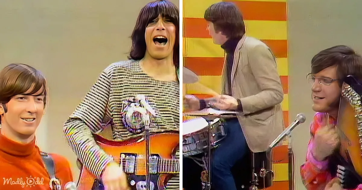 A man in a striped shirt plays guitar, another in a red turtleneck smiles, and a drummer in a beige suit is seen in the...