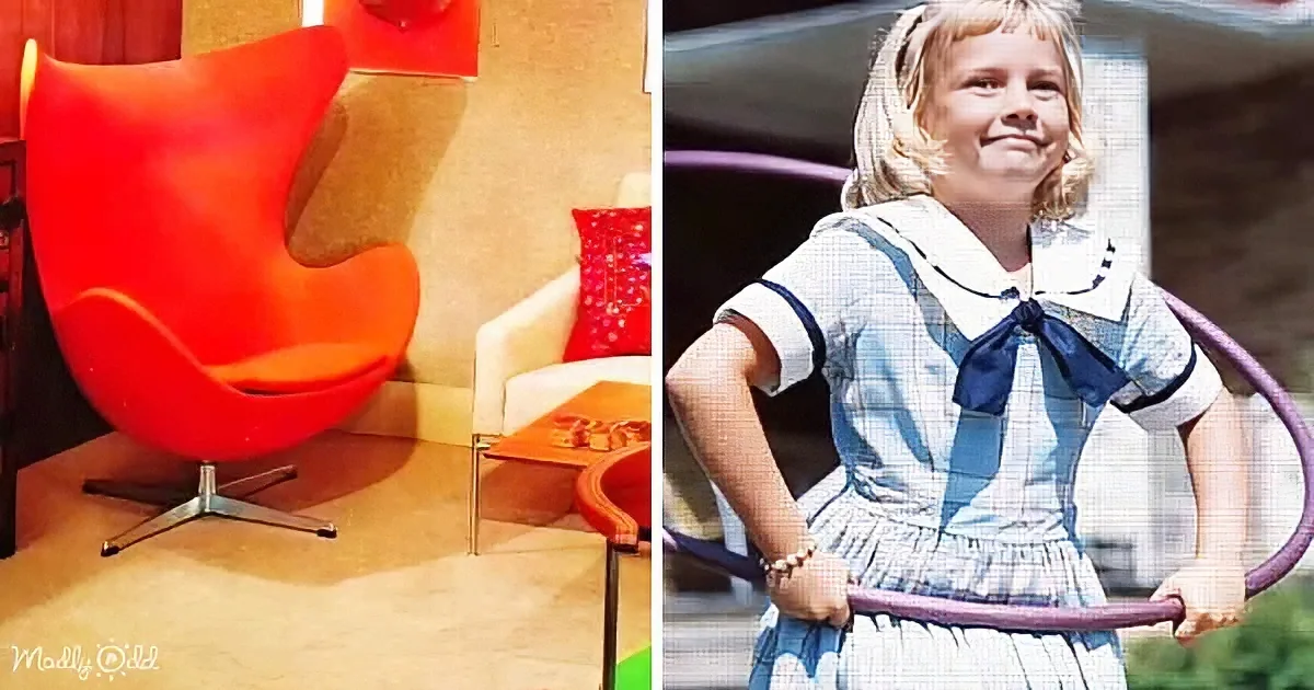 A red Egg Chair by Arne Jacobsen and a young girl in a sailor dress holding a hula hoop.