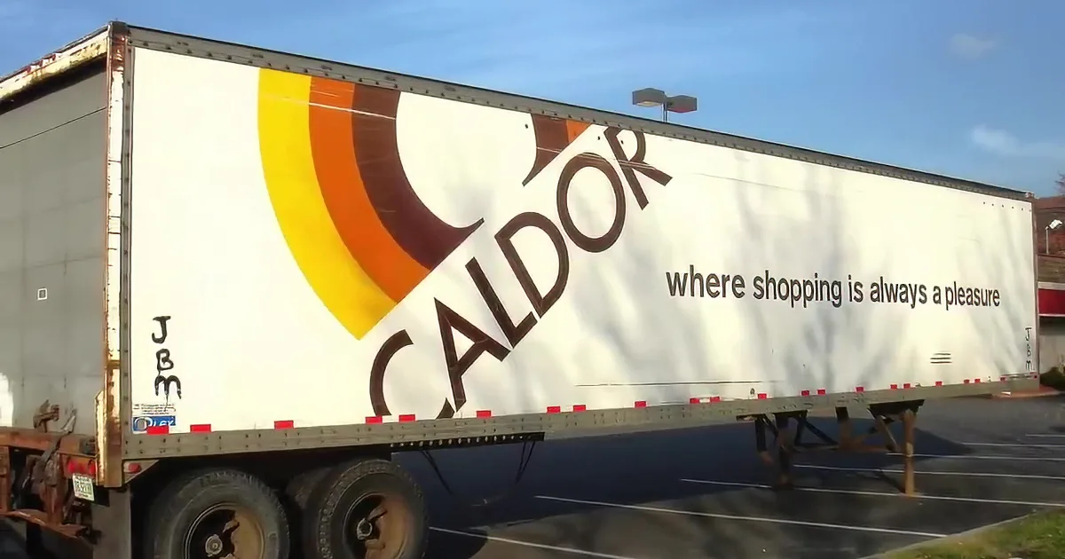 A Caldor store with people exiting, cars parked, and a "Coming Soon" sign visible.