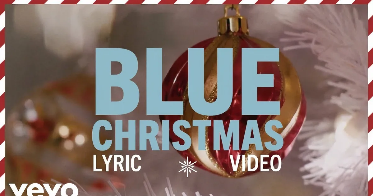 The text "BLUE CHRISTMAS" over a blurred background of red and green lights, possibly Christmas decorations.