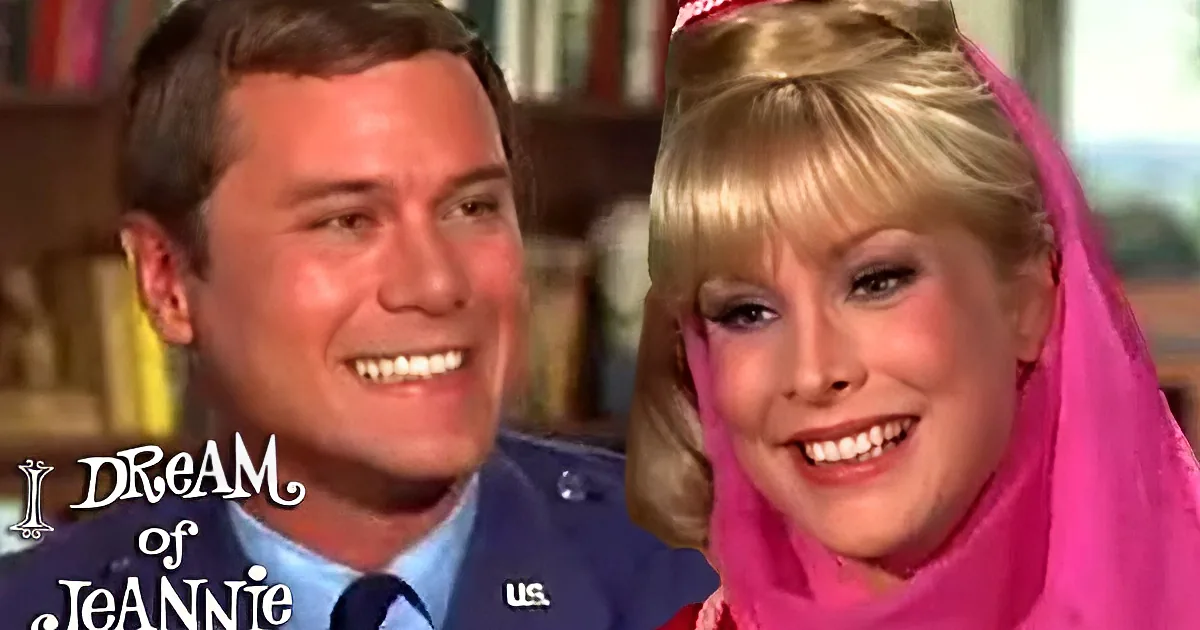 A man in a blue uniform and a woman in a pink outfit are smiling together.