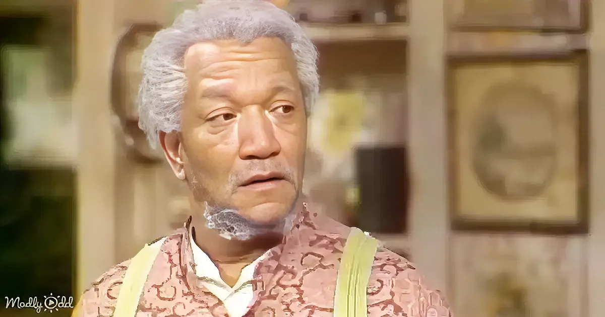 An older man with gray hair and a patterned shirt looks to the side, with a blurred background.