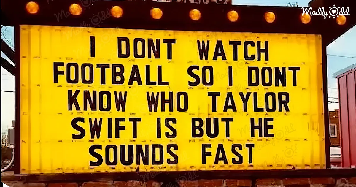 A yellow sign with black text humorously states, "I don't watch football so I don't know who Taylor Swift is but he...