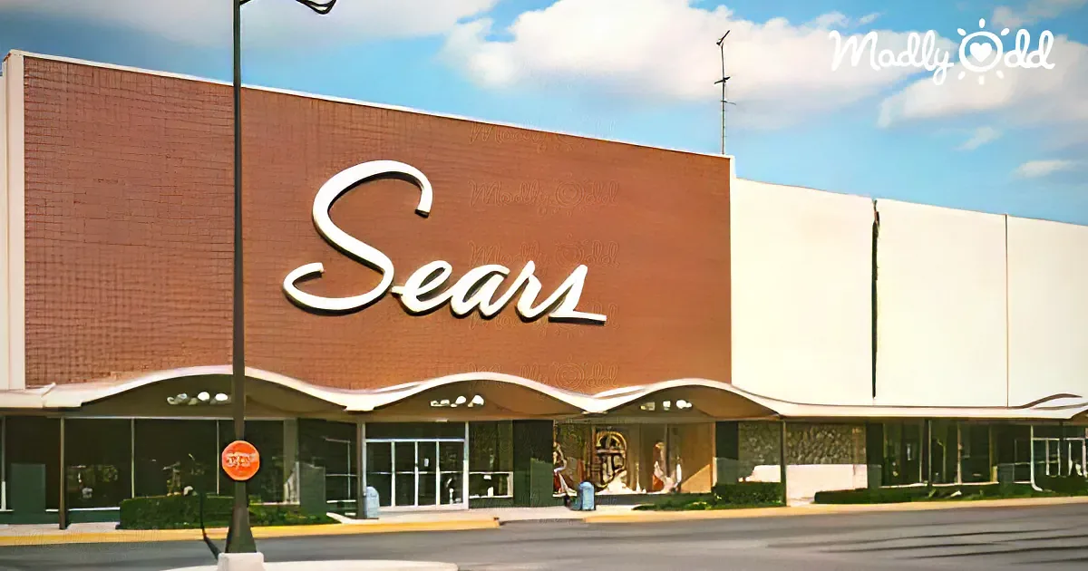 A Sears store with a large sign and a brick facade under a partly cloudy sky.