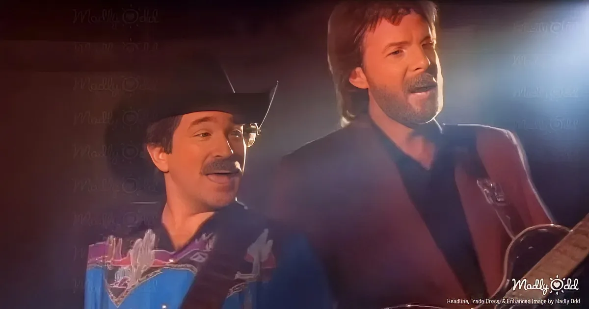 Two men, one in a cowboy hat, are singing and playing guitar on stage.