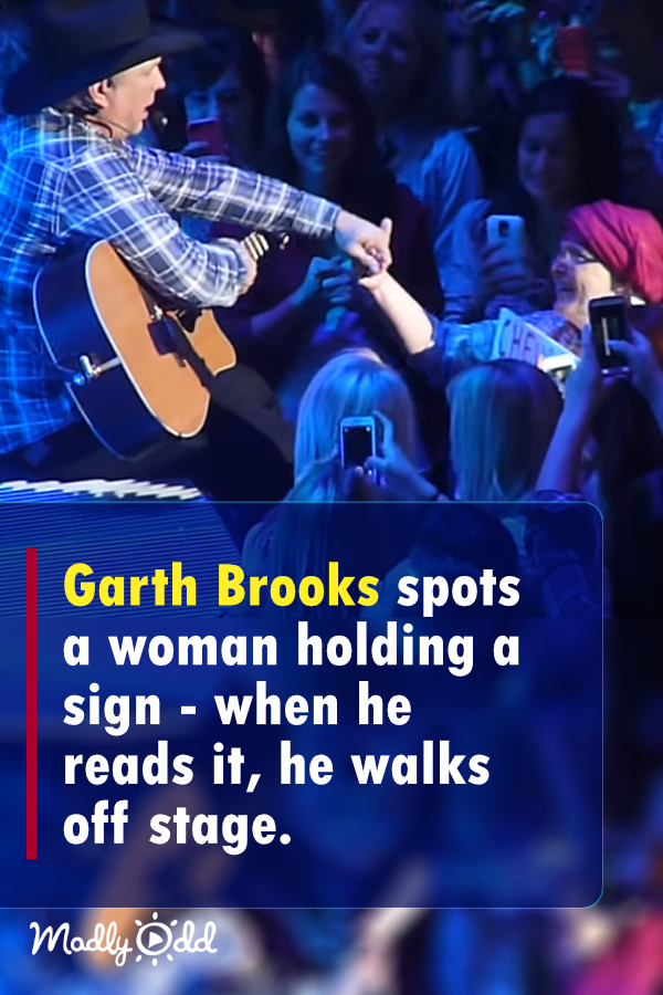 Garth Brooks spots woman holding sign ― when he reads it, he walks off stage