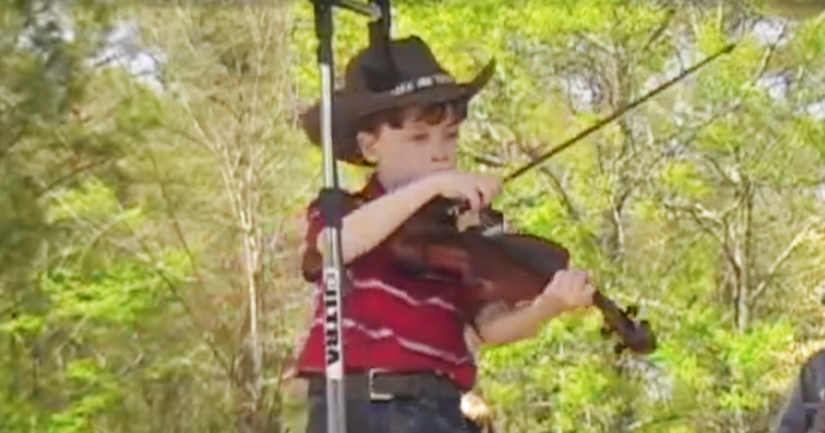 Boy at fair playing fiddle