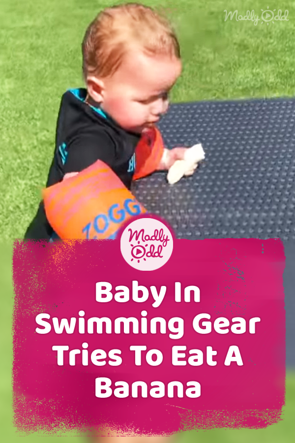 Baby In Swimming Gear Tries To Eat A Banana