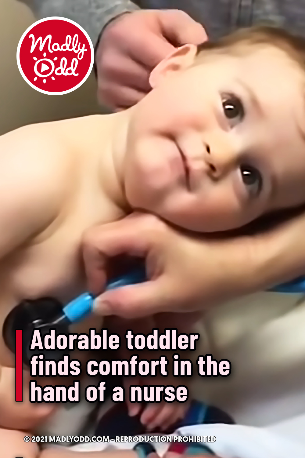 Adorable toddler finds comfort in the hand of a nurse