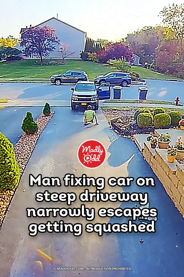 Man fixing car on steep driveway narrowly escapes getting squashed