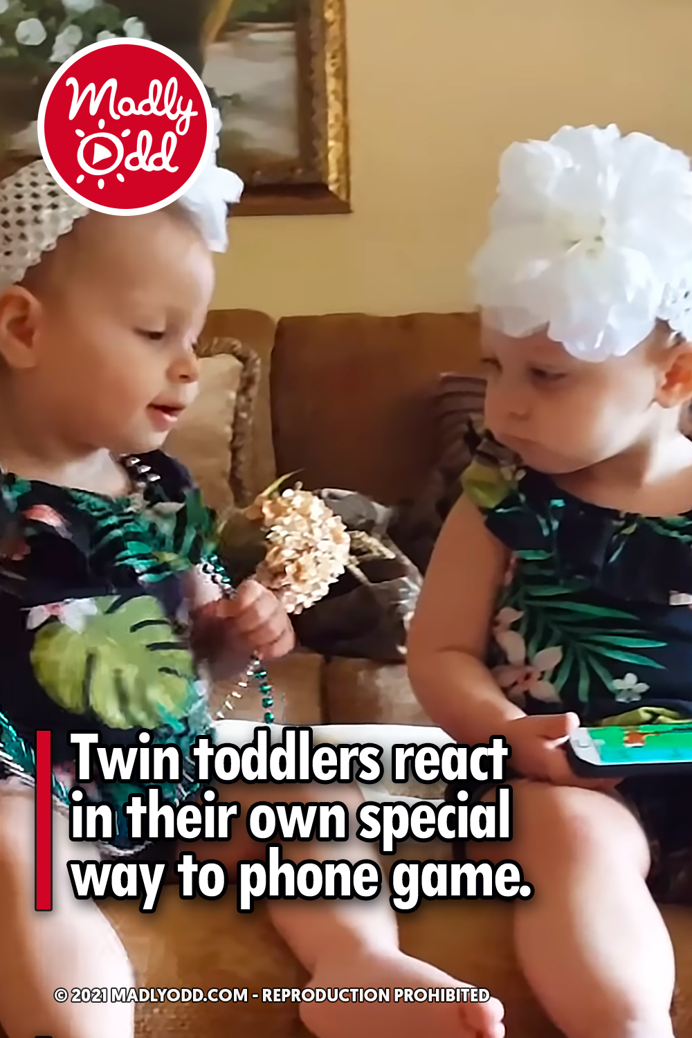 Twin toddlers react in their own special way to phone game.