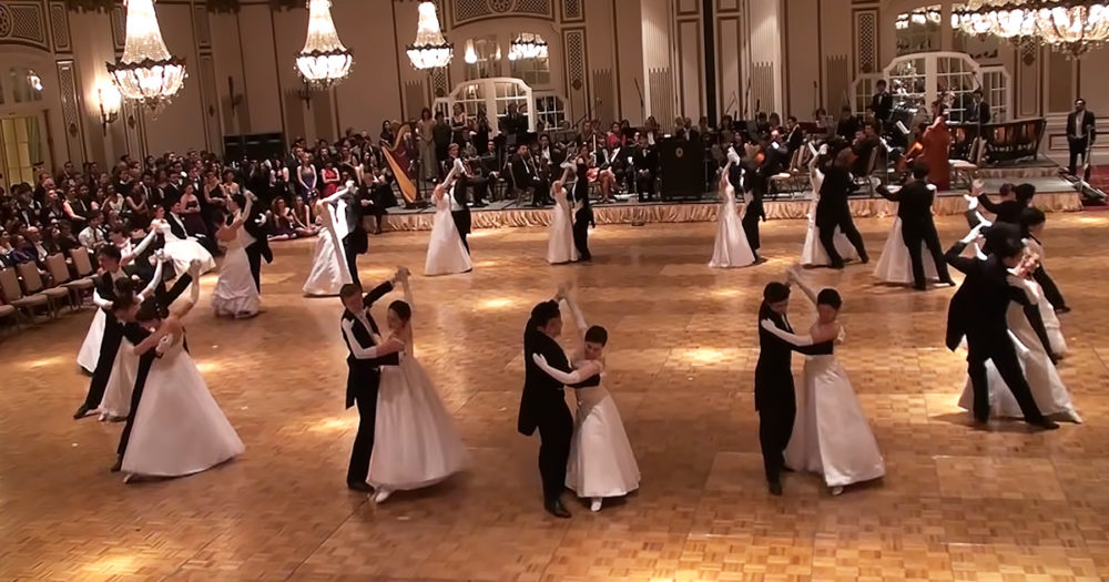 Couples performing complex synchronized Viennese Waltz
